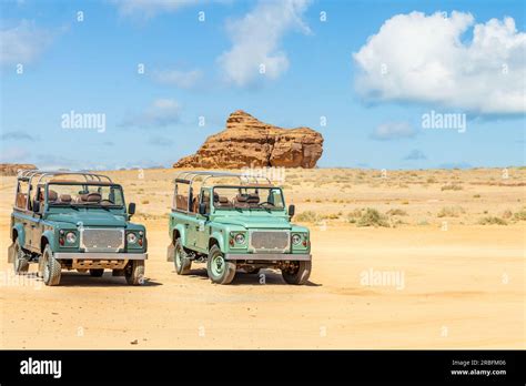 Off Road Cars And Desert Cliffs Formations Landscape At Hegra Al Ula