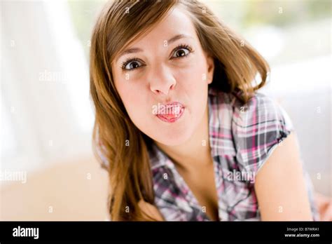 Cheeky woman sticking out tongue hi-res stock photography and images