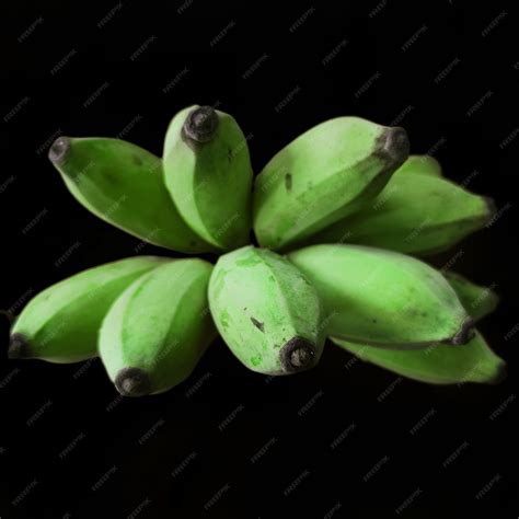 Premium Photo | Bunch of green bananas on a black background