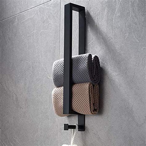 Two Towels Hanging On The Wall Next To A Towel Rack