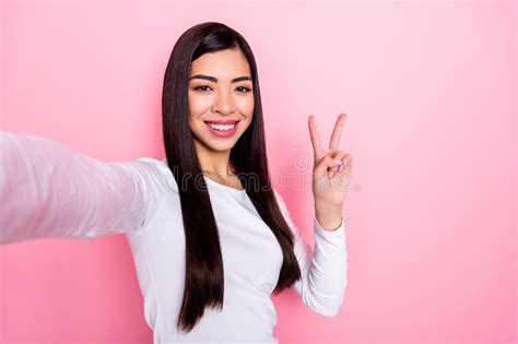 Photo Of Pretty Millennial Brunette Lady Do Selfie Show V Sign Wear White Shirt Isolated On Pink