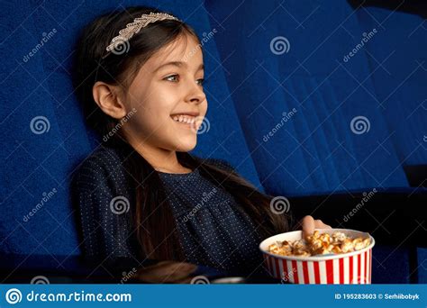 Little Smiling Girl Eating Popcorn in Cinema. Stock Image - Image of positivity, bucket: 195283603