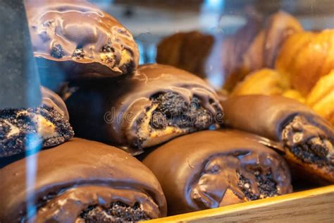 Poppy Seed Roll Covered With Chocolate Glaze Close Up On A Marble