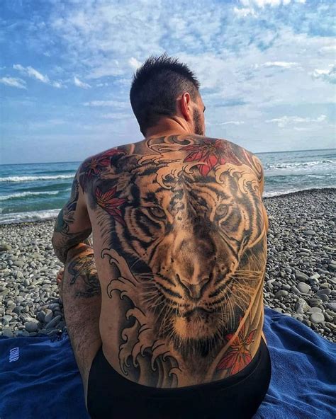 Man with Tiger Tattoo on Beach