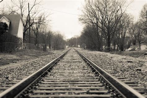 Picturesque Rural Village With A Vintage Railroad Track Running Through