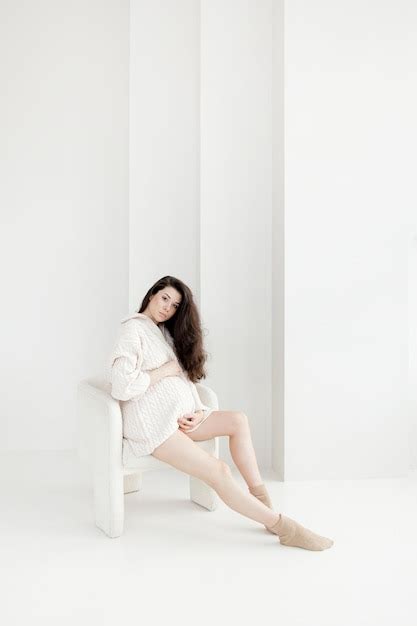 Premium Photo Pregnant Brunette Girl In An Oversized Knitted Sweater