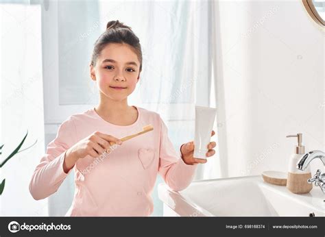 Brunette Girl Holding Toothbrush Modern Bathroom Emphasizing Importance