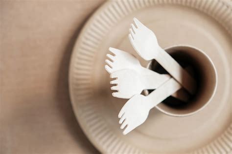 Wooden Forks And Paper Cups With Plates On Kraft Paper Background