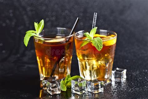 Two Glasses With Cold Traditional Iced Tea With Lemon Mint Leaves And