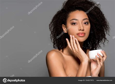 Naked African American Girl Applying Face Cream Isolated Grey Stock