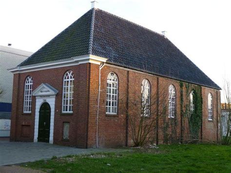 An Old Brick Church With Arched Windows And Ivy Growing Up The Side Of