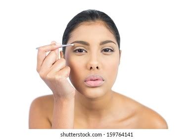 Serious Nude Brunette Using Tweezers On Stock Photo 159764141