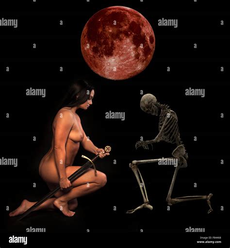 Sexy Nude Warrior Woman With A Broad Blade Sword With A Skeleton Under A Red Moon Stock Photo