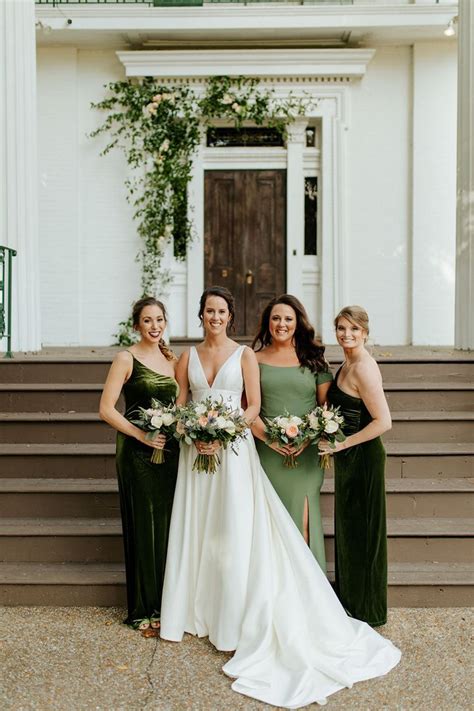 four bridesmaids in green dresses standing on steps