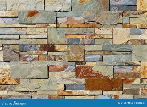 Stone Cladding Wall Made Of Stacked Slabs Of Natural Multicolor Rocks