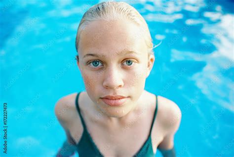 Blonde Teen Girl With Short Hair Slicked Back In Green One Piece In Swimming Pool Photos Adobe