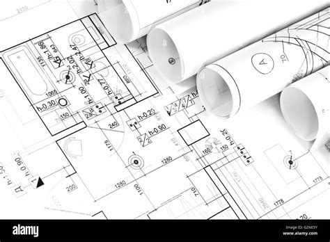 Architectural background with rolls of technical drawings and work ...