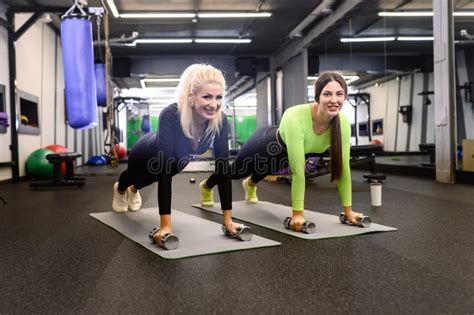 Sporty Women Working Out In The Gym Two Female Athletes Perform Push