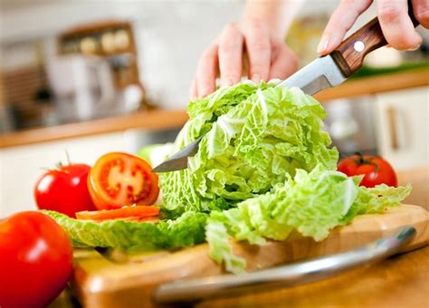 Premium Photo Womans Hands Cutting Lettuce Behind Fresh Vegetables