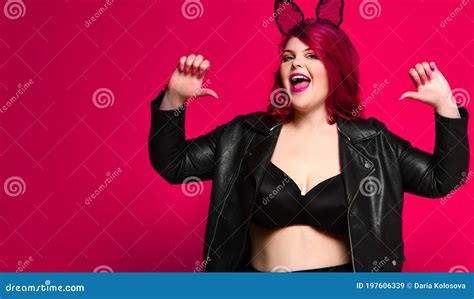 Cute Plus Size Brunette With Black Bunny Ears In Leather Jacket And Underwear Posing On Red