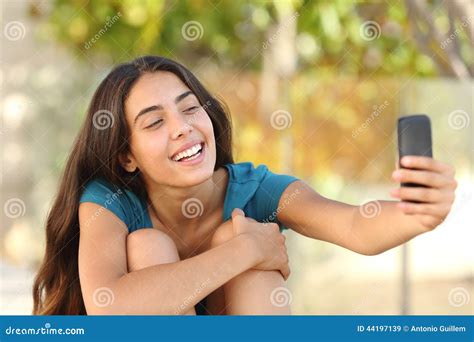 Happy Teen Girl Taking A Selfie Portrait With Her Smart Phone Stock