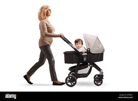 Full Length Profile Shot Of A Mature Woman Pushing A Baby In A Stroller