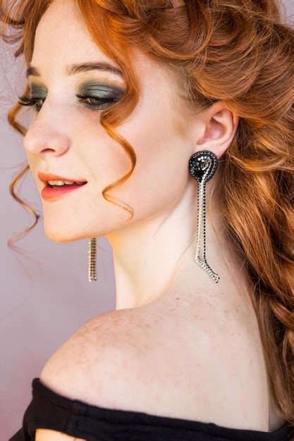 Premium Photo Beautiful Redhaired Girl With Straight Earrings And Naked Shoulders Posing On A