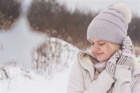 A Blonde Girl In Winter Clothes Walking On A Snowy Steppe Smiling Woman In Light Clothes In