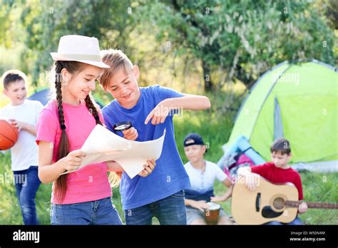 Little Children With Map Resting At Summer Camp Stock Photo Alamy