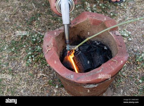 Mans Hand Lighting A Charcoal Stove Prepare To Cook Stock Photo Alamy