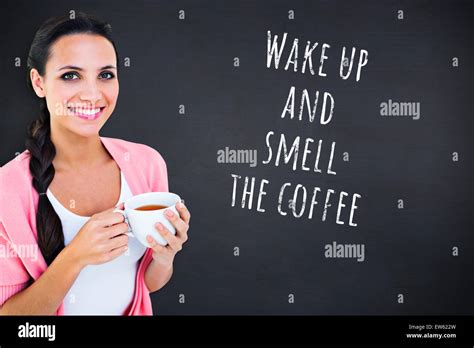 Composite Image Of Pretty Brunette Holding A Mug Stock Photo Alamy