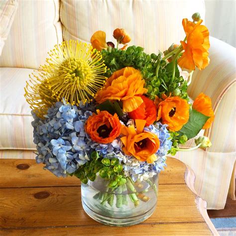 Blue Hydrangea And Orange Ranunculus Floral Arrangement
