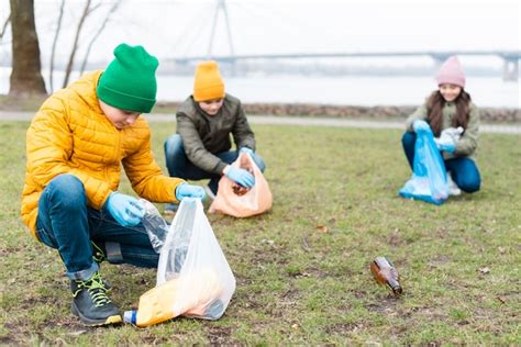 Free Photo Long Shot Of Kids Cleaning The Ground