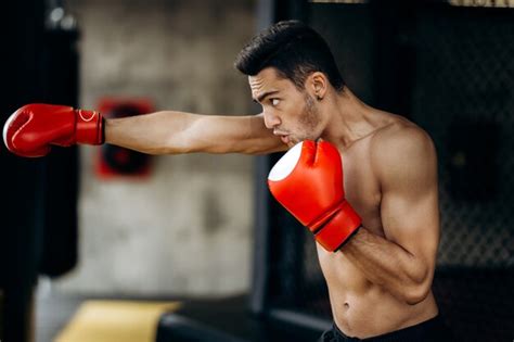 Premium Photo Sportsman With A Naked Torso And The Red Boxing Gloves On His Hands Stands Hits