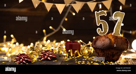 Number 57 Golden Festive Burning Candles In A Cake Wooden Holiday