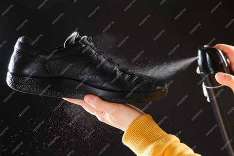 Premium Photo | The process of applying a waterrepellent spray to shoes