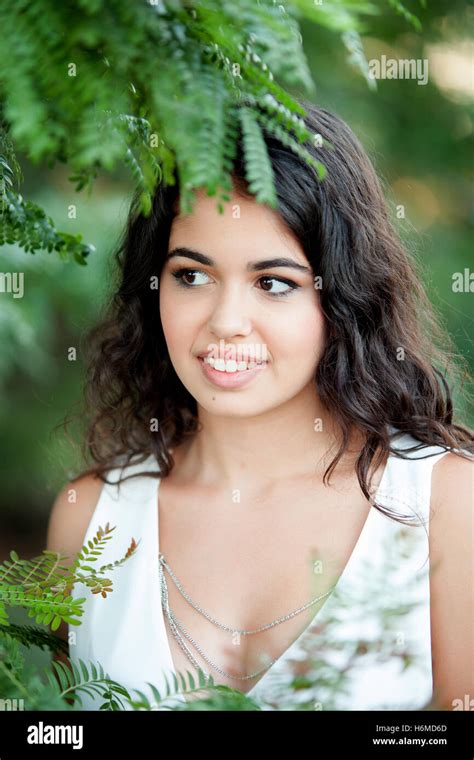 Beautiful Brunette Girl Relaxing In The Park Wiht Many Plants Of Background Stock Photo Alamy