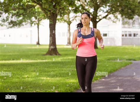 Fit Brunette Jogging In The Park Stock Photo Alamy