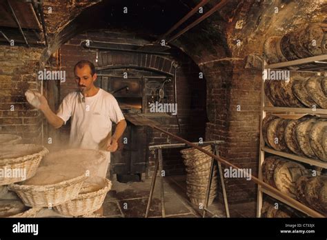 Baker Baking Bread In The Bakery Wood Fired Oven Boulangerie In Stock