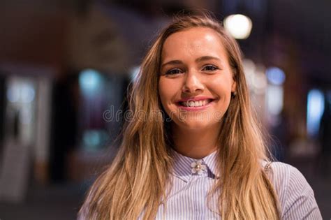 Close Up Portrait Of A Beautiful Blonde Woman Smiling Outdoors In The Evening Stock Image