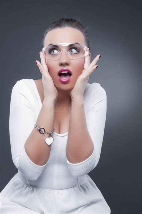 Caucasian Brunette Woman With Both Hands Lifted Showing Surprised Facial Expression Stock Photo