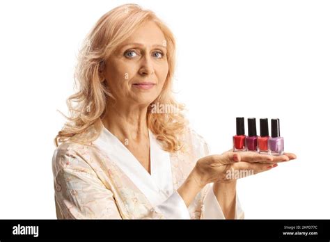 Beautiful Mature Woman In A Bathrobe Holding Nail Polishes Isolated On