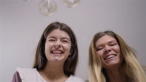 Close Up Two Cheerful Women Looking At Camera Laughing Out Loud With