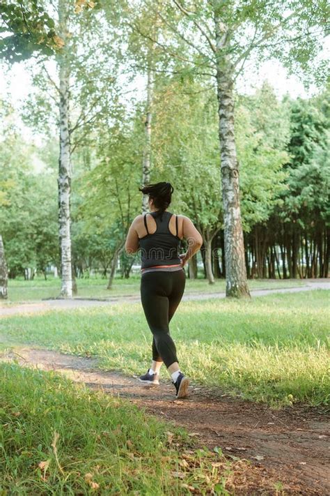 A Charming Brunette Woman Plus Size Body Positive Practices Sports In Nature Stock Image Image