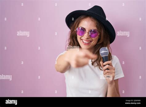 Beautiful Brunette Woman Singing Song Using Microphone Smiling Happy Pointing With Hand And