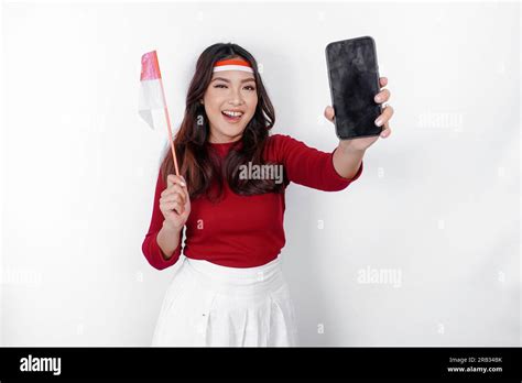 A Happy Asian Woman Wearing Headband Holding Her Phone And Indonesian