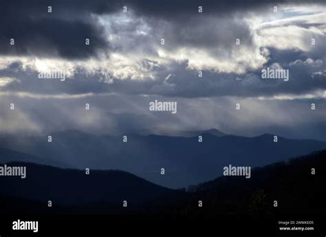 Storm clouds with sunlight over mountain range; Fairview, North ...