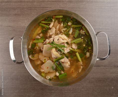 Thai Clear Tom Yum Spicy Chilli Hot Soup With Seafood Meat And Vegetables In Hot Pot In Wood