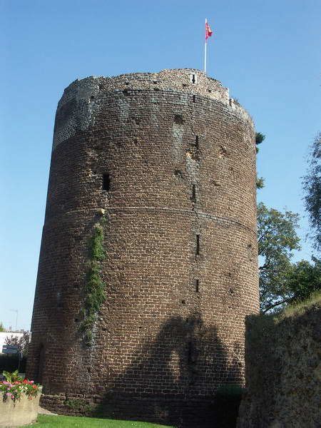 A Tall Brick Tower Sitting On Top Of A Lush Green Field