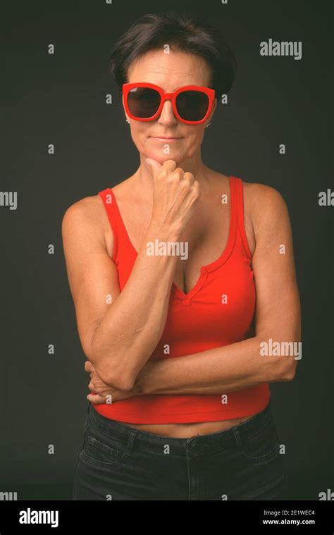 Mature Beautiful Woman With Short Hair Against Black Background Stock Photo Alamy